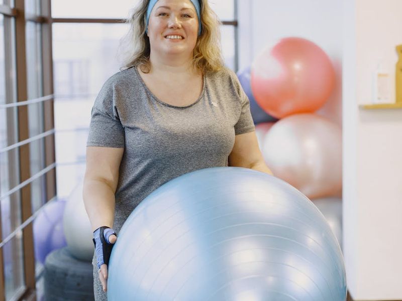 Person doing cardio exercises in bright studio