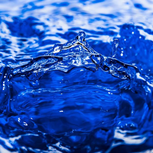 Water splash reflecting blue light